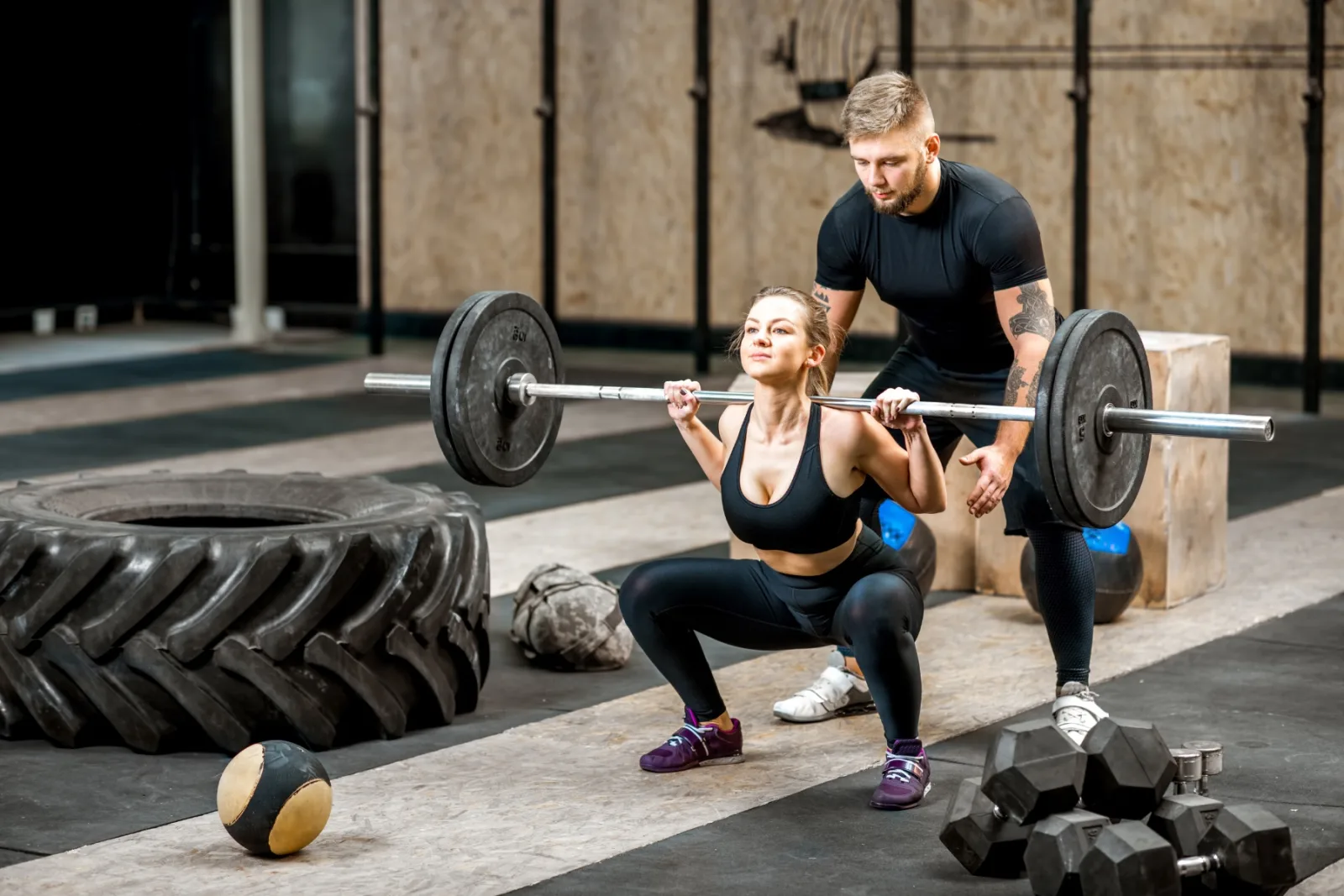 Woman Lifting Up A Burbell With Coach In The Gym 2026 01 08 22 30 52 Utc