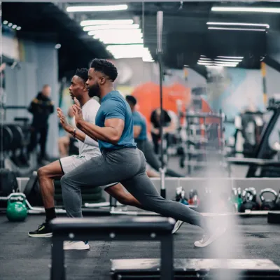 Two Young Men Doing Lunges In Modern Gym 2026 01 09 10 55 09 Utc