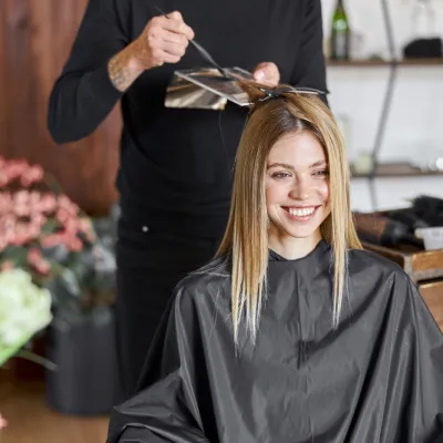 Woman Smiling While Getting Hair Styled In Salon 2026 01 05 06 05 03 Utc