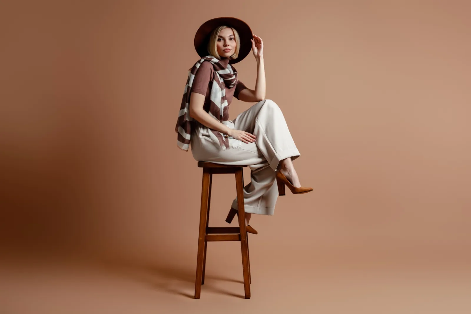 Stylish Woman Sitting On Stool Wearing Hat 2026 01 09 06 38 42 Utc