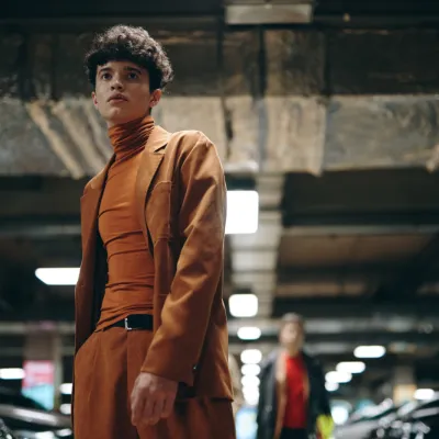 Stylish Young Man In An Orange Outfit Standing In 2026 03 24 06 17 36 Utc