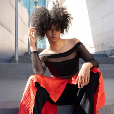 Model In Black Top And Red Dress On Steps 2026 03 16 06 19 51 Utc